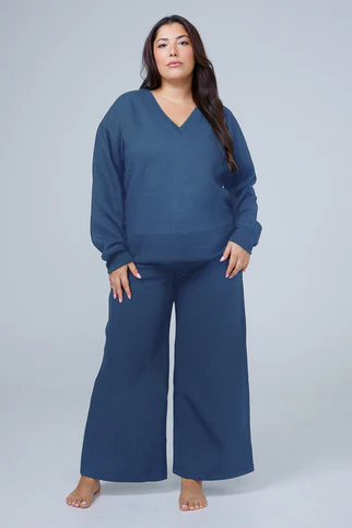 Woman in a navy knit loungewear set from Hernest Project, an eco-conscious fashion brand on Shopify