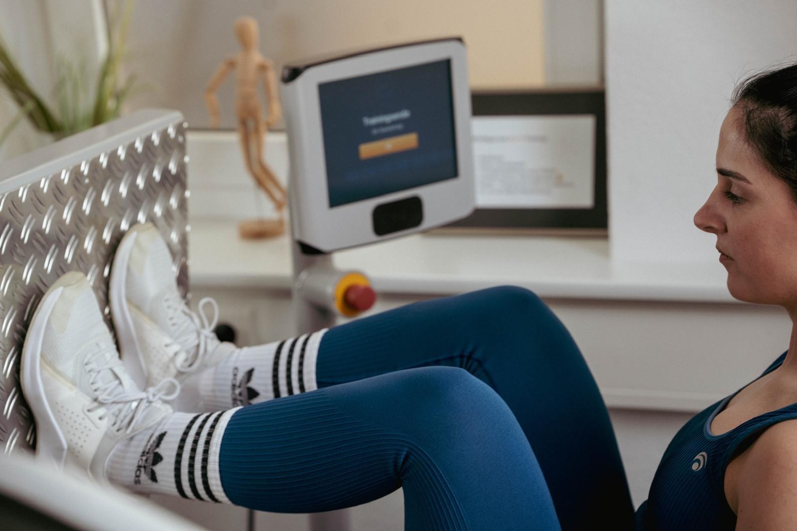 Woman exercising on a computer-controlled leg training machine